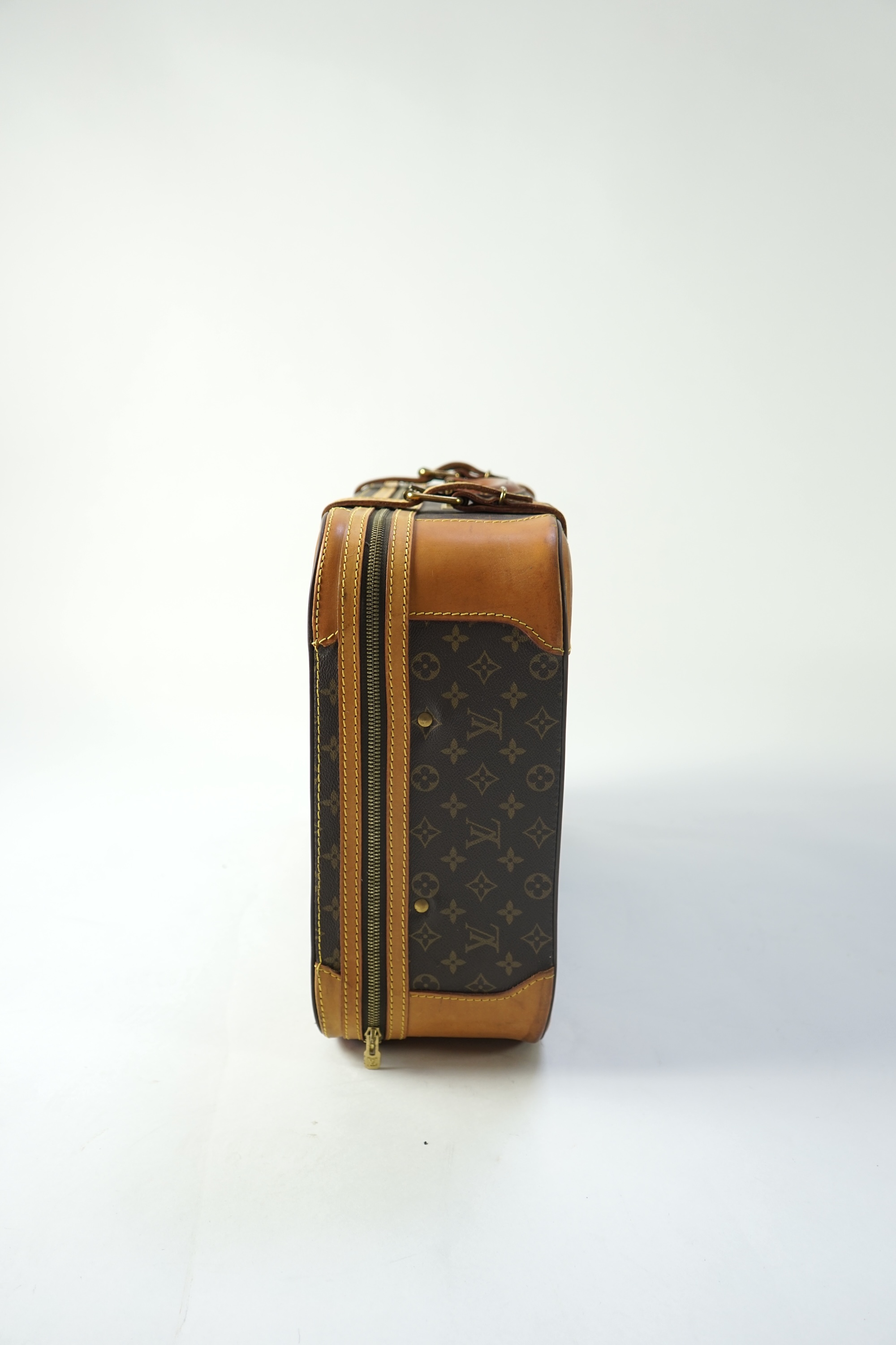 A Louis Vuitton monogrammed canvas with leather trim soft sided suitcase